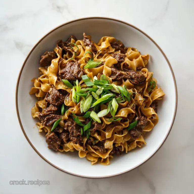 Close-up of glistening wide egg noodles coated in rich beef sauce, served in a white bowl, garnished with fresh parsley.